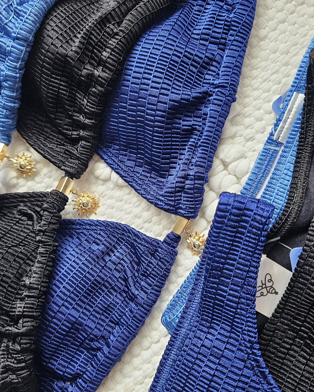 Solar Glow Sun Charm Bikini Top colors black, petroleum blue, and navy, close-up detail, Beeluxxe