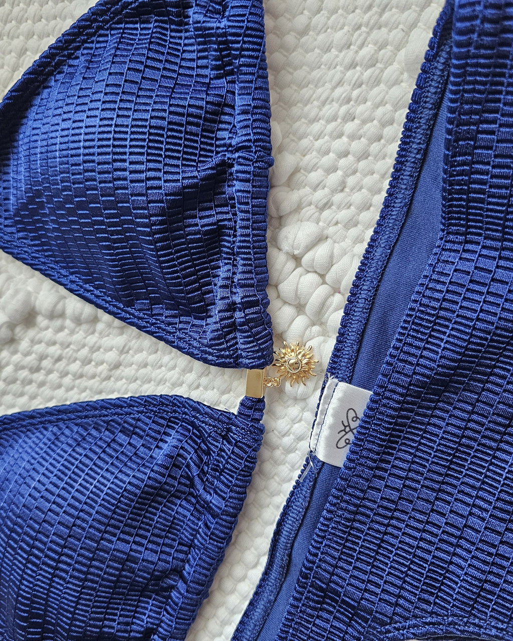 Solar Glow Sun Charm Bikini Top in navy, sun charm and fabric detail close-up, Beeluxxe